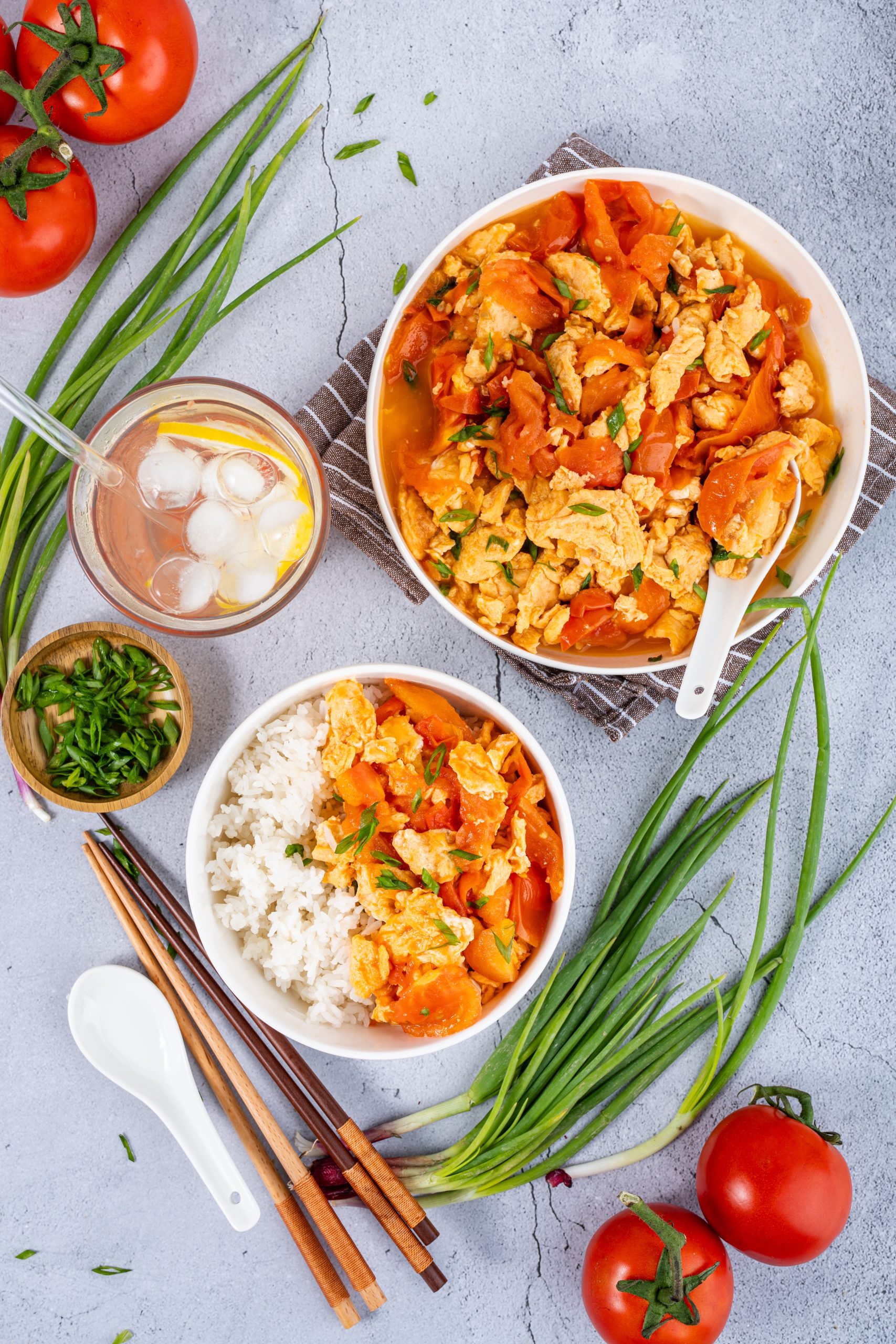 Macro shot of Stir Fried Tomato and Egg Recipe showing juicy tomato chunks, golden scrambled eggs, and garnished scallions.