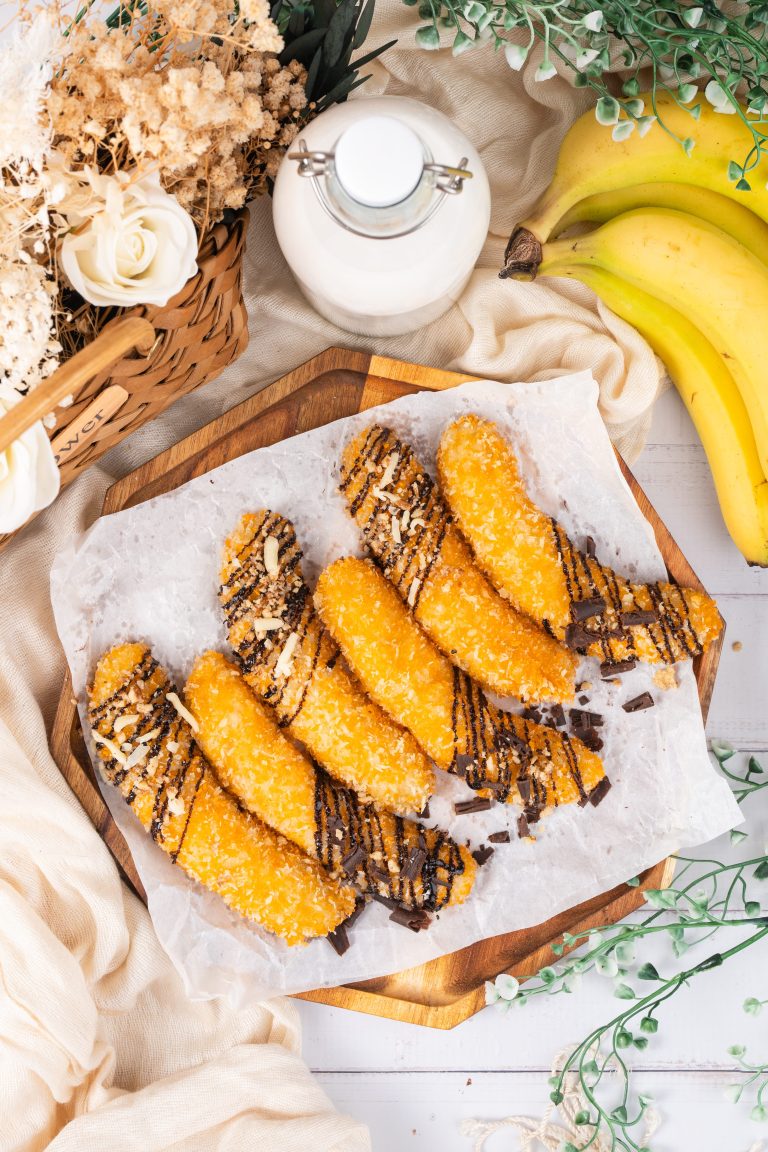 Top view of golden banana fritters with chocolate topping and rustic food styling