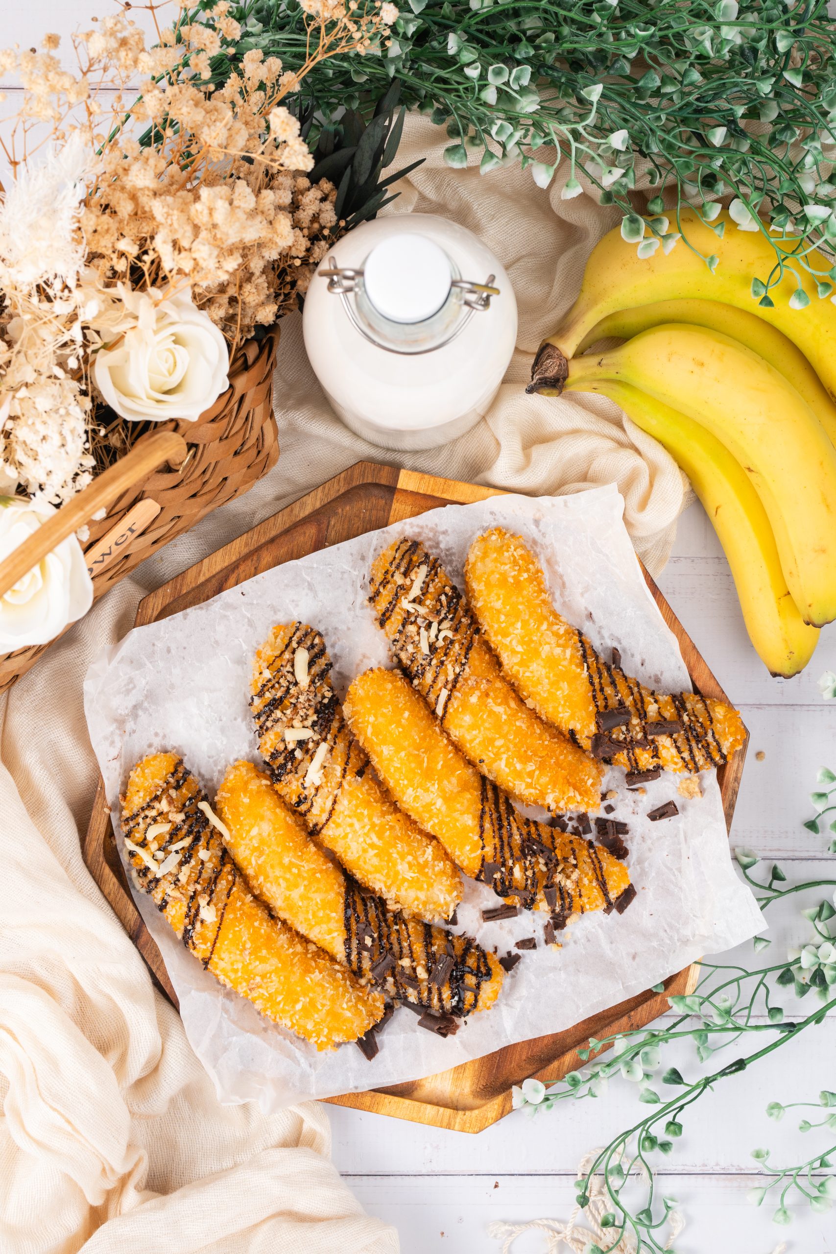 Top view of golden banana fritters with chocolate topping and rustic food styling