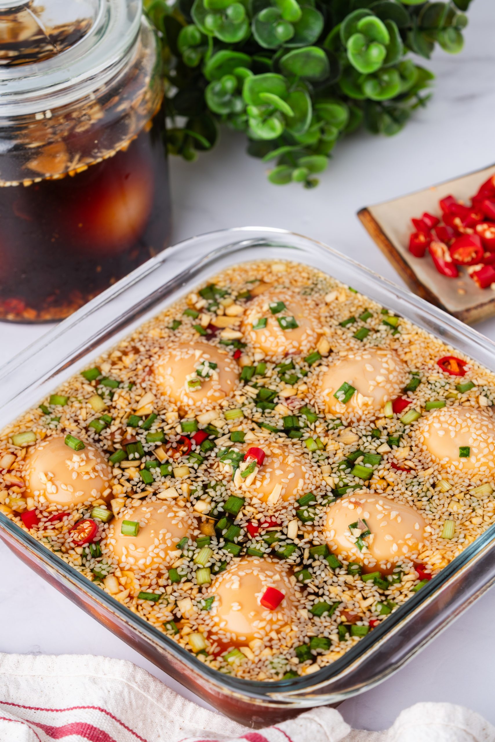 Korean Marinated Eggs (Mayak Gyeran) soaking in soy sauce, garlic, sesame seeds, scallions, and red chili