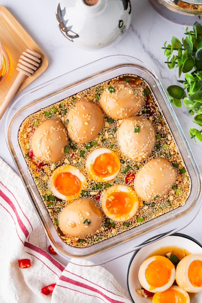 Korean Marinated Eggs (Mayak Gyeran) with jammy yolks, sesame seeds, scallions, and chili in soy sauce