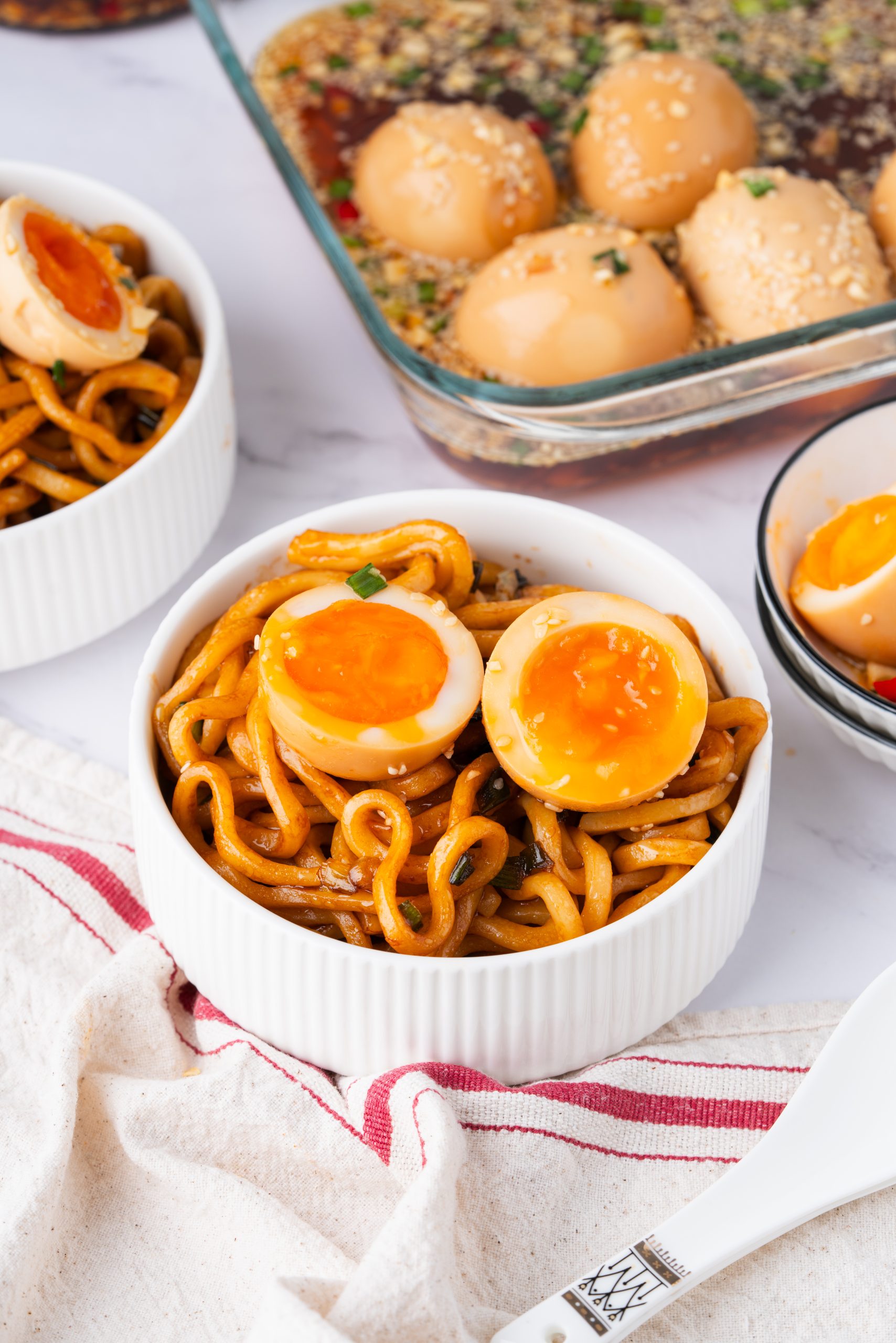 Bowl of chewy udon noodles topped with Korean Marinated Eggs (Mayak Gyeran) and rich soy sauce glaze