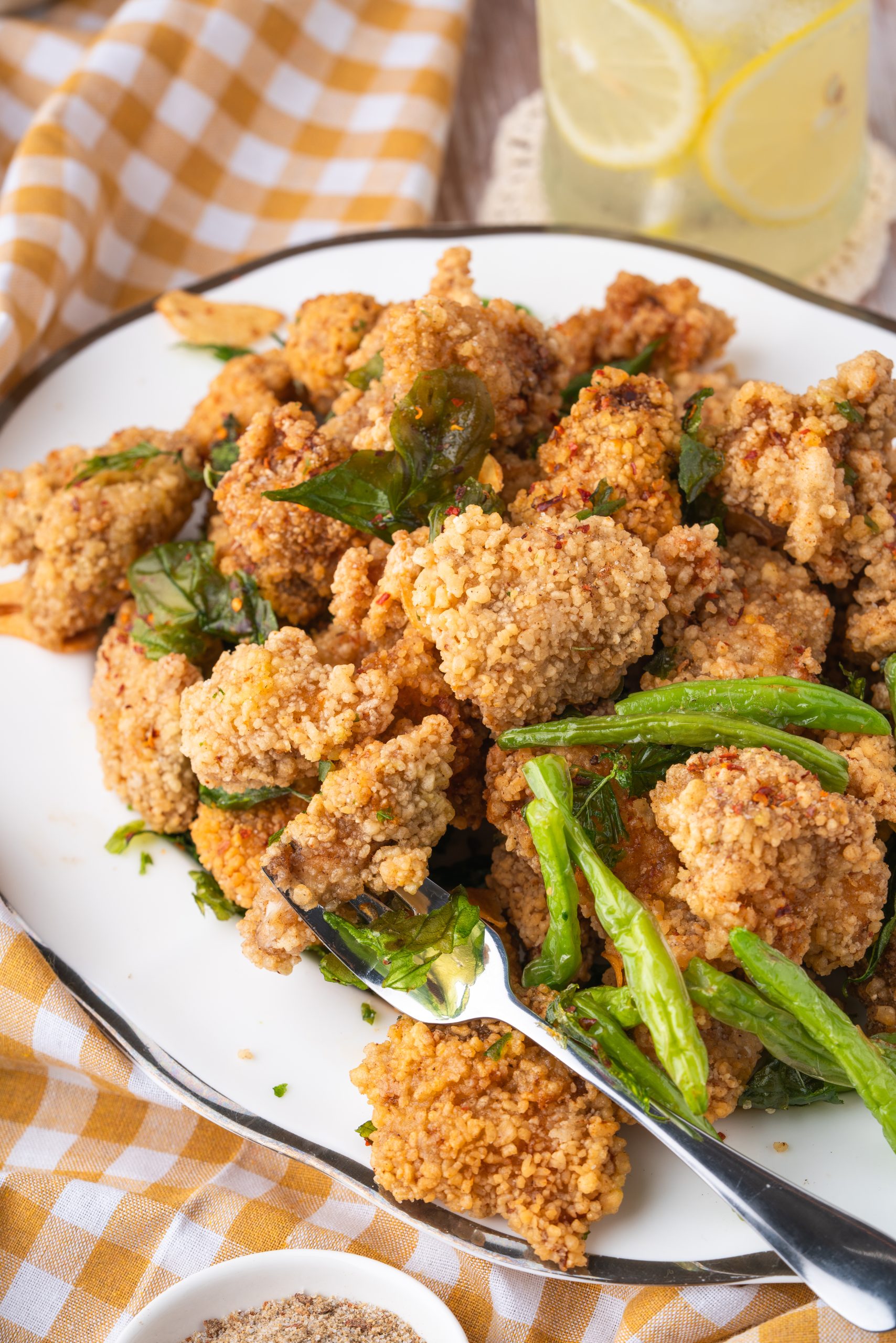 Crispy Taiwanese popcorn chicken showing tender inside and basil garnish