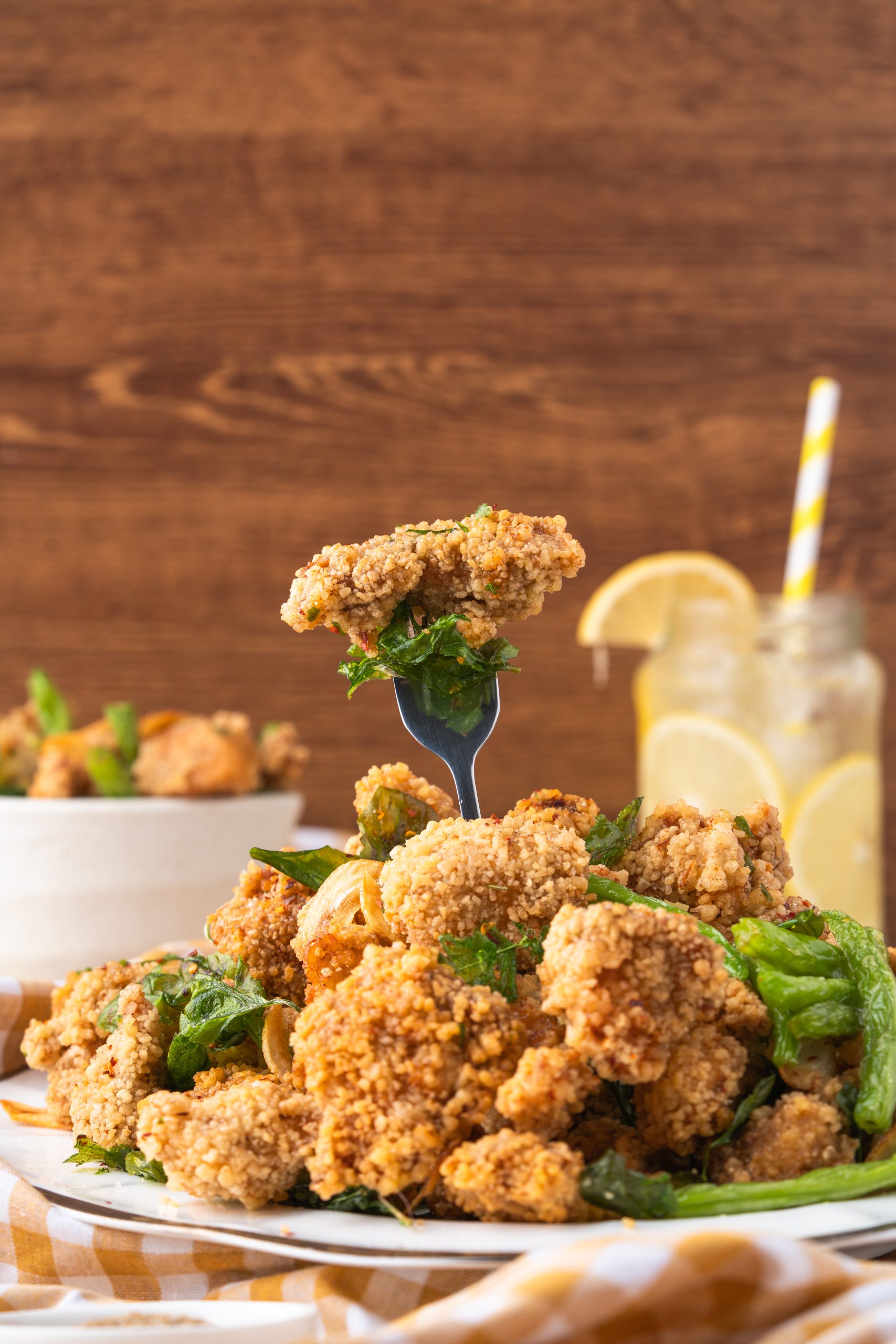 Taiwanese popcorn chicken garnished with basil leaves and garlic chips