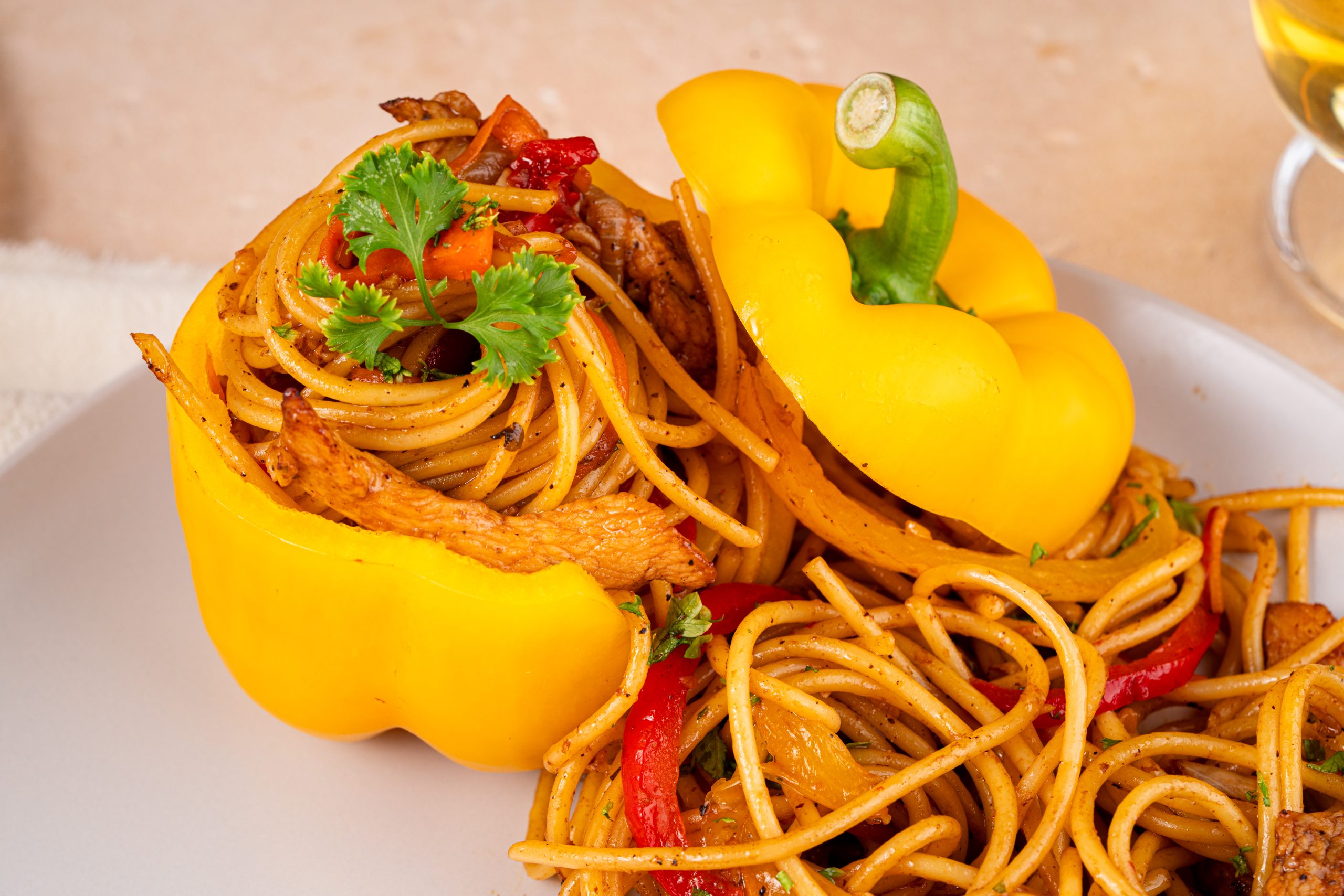 Plated Stir-Fry Pasta in yellow bell peppers, showcasing a vibrant and appetizing presentation.