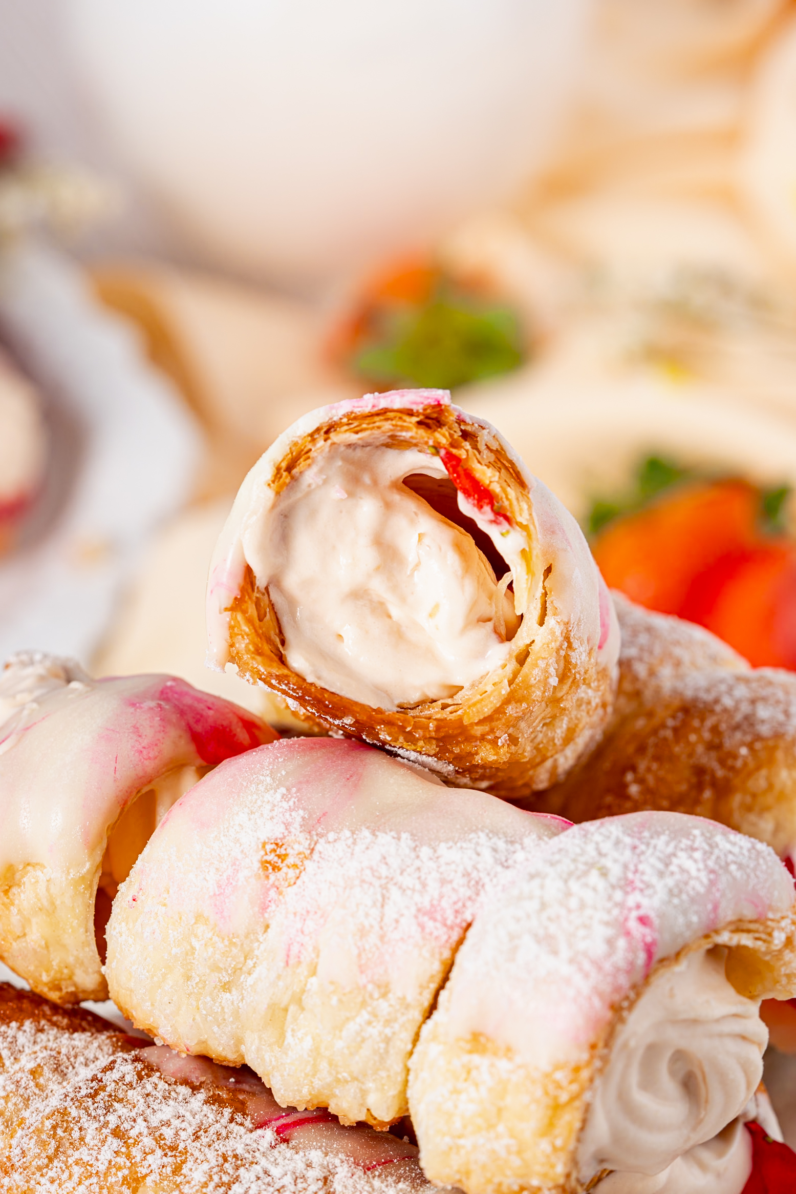 Close-up of a crispy Cream Horn with creamy filling and strawberry slices, showing the flaky pastry texture and smooth whipped filling.