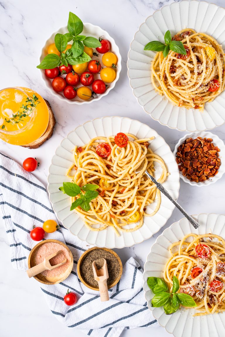 Traditional Cacio e Pepe recipe presentation featuring creamy spaghetti, cracked black pepper, and Pecorino Romano.