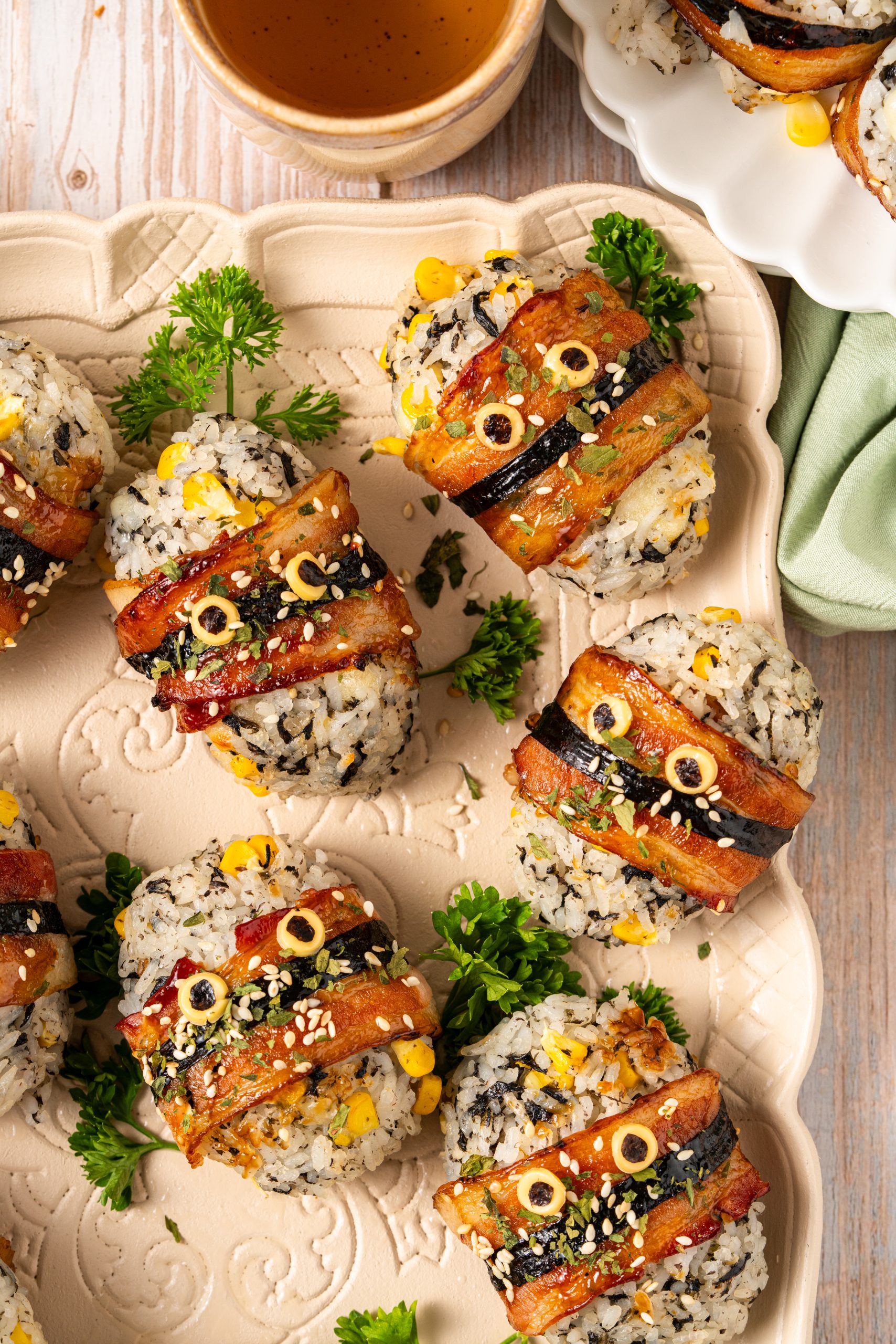 Golden crispy bacon-wrapped rice balls with cheesy fillings and parsley as garnish