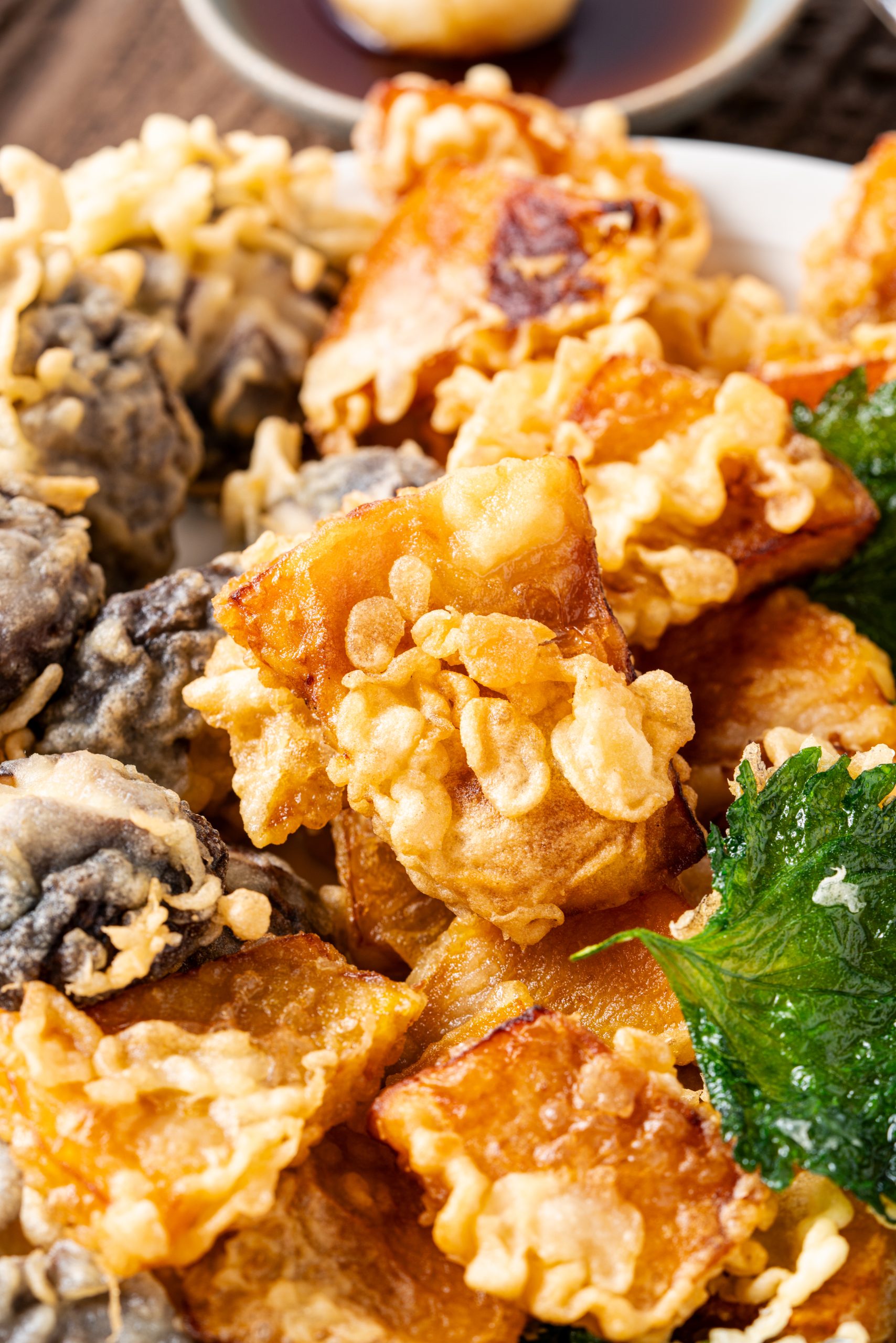 Close-up of pumpkin tempura, lightly battered and fried until golden and crunchy.
